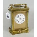 A GOOD BRASS ENCASED REPEATER CARRIAGE CLOCK striking on a gong, having a circular white dial