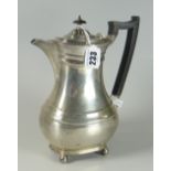 GEORGE V SILVER HOT WATER JUG/COFFEE POT of baluster form raised on four ball feet. Sheffield