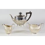 THREE PIECE SILVER TEA SET, comprising tea pot, sucrier and cream jug of half fluted oval form