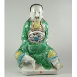 JAPANESE PORCELAIN FIGURE OF A SEATED MAN IN DRAGON ROBES unglazed to base & unmarked, old Bluett