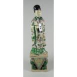 JAPANESE PORCELAIN FIGURE HOLDING SCEPTRE with flowing floral & inset decorated robes on symbolic