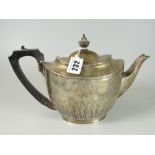VICTORIAN SILVER OVAL TEAPOT having half body leaf decoration with ebonized handle and finial.