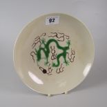 CHINESE PORCELAIN SHALLOW DISH RAISED ON CIRCULAR FOOT decorated with green five clawed dragon