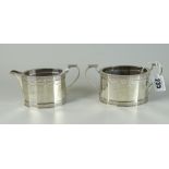 GEORGE V SILVER MATCHING TWIN HANDLED SUCRIER AND CREAM JUG of tetradecagon form with engraved