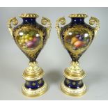 A PAIR OF FREDERICK CHIVERS FRUIT DECORATED COALPORT PORCELAIN VASES of pedestal form with narrow