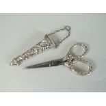 VICTORIAN PAIR OF SILVER AND STEEL SCISSORS in repousse decorated case. Birmingham 1889 by Levi &
