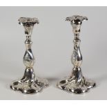 PAIR OF NORWEGIAN SILVER (LOADED) CANDLESTICKS, of spiral form with repousse scroll decoration. (
