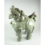 CHINESE CELADON GLAZE DOG OF FOO OR GUARDIAN LION the removable head revealing cavity, 29cms high