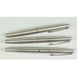 THREE VINTAGE STAINLESS STEEL PARKER FLIGHTER FOUNTAIN PENS with chrome trim