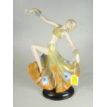 A CONTINENTAL PORCELAIN ART DECO FIGURE of a dancing lady in long floral dress and with leg kick and