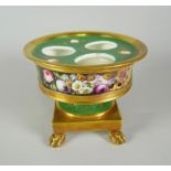 A NINETEENTH CENTURY PORCELAIN INKSTAND in green ground with gilding and of pedestal form with