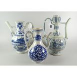 THREE ORIENTAL PORCELAIN BLUE & WHITE EWERS OR WINE JUGS all similarly decorated with foliate floral