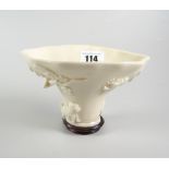 CHINESE BLANC-DE-CHINE LIBATION CUP ON HARDWOOD STAND the cup depicting fish, animals & dragon,