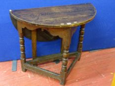An antique oak peg joined construction half moon side table with a single drop leaf