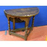 An antique oak peg joined construction half moon side table with a single drop leaf