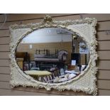 A Victorian painted Rococo-style oval bevel edged wall mirror