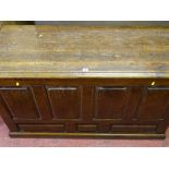 An antique pine panel fronted blanket chest of peg joined construction