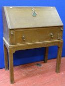 An oak fall front Dickens-type desk