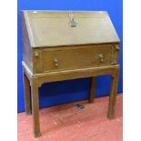 An oak fall front Dickens-type desk