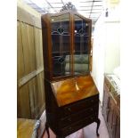 A vintage walnut full front bureau bookcase with leaded glass top doors