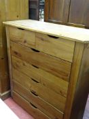 A modern pine chest of two short over five long drawers