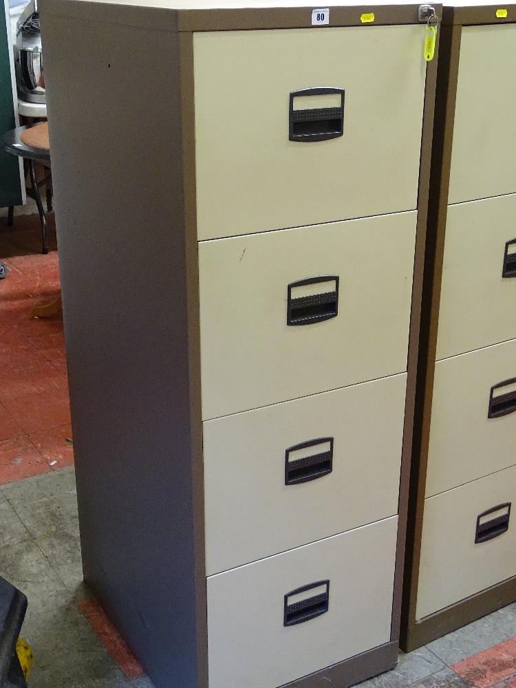 A modern four-drawer metal file cabinet with key