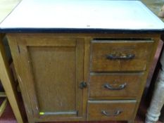 A vintage pine kitchen cupboard base with white enamel top