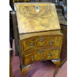 A vintage fall front walnut ladies bureau with concave lower drawers
