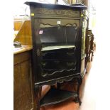 An ebonized Edwardian single-glazed door corner cabinet