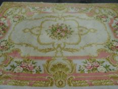 A pink bordered & cream ground floral patterned carpet, 298 x 202cms approx.