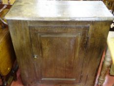 An antique oak single-door cupboard