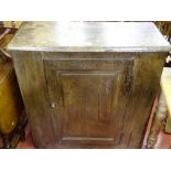 An antique oak single-door cupboard