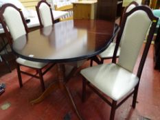 A mahogany extending dining table & four upholstered high back dining chairs