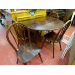 Dark wood Ercol? drop leaf circular table and four chairs