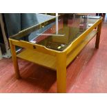 Small coffee table with smoky glass top and undershelf, by Myer