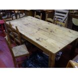 Substantial wooden rustic style dining table (approx 250 x 125 cms) and six rush seated chairs by