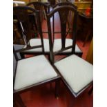 Set of four dining chairs with shell upholstered pads