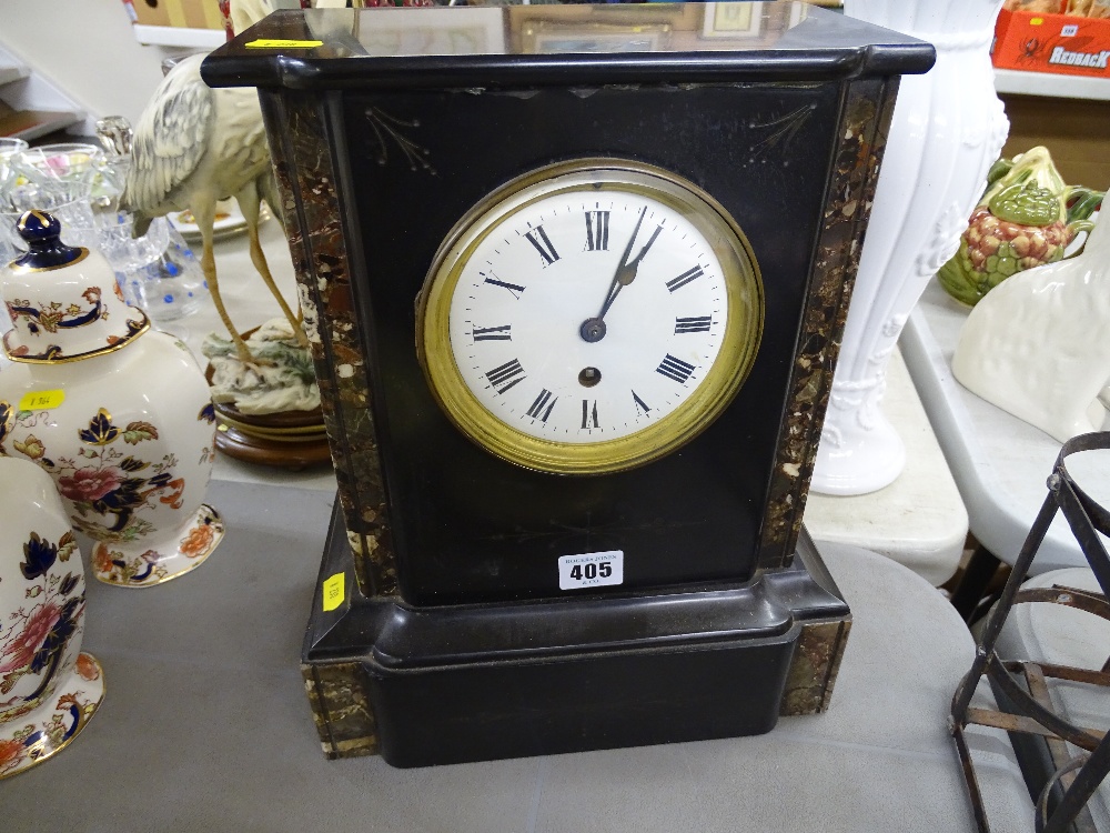 An ornamental slate mantel clock with enameled dial