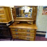 Circa 1900 walnut mirrored dressing chest having two uppers drawers with a shelf over two short
