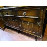 Priory style sideboard having triple drawers and doors with linenfold carving