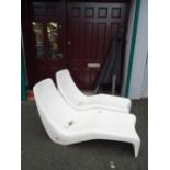 Pair of fibreglass vintage recliners and metal framed overhead parasol