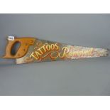Vintage timber saw with painted detail saying 'Tattoos Removed'
