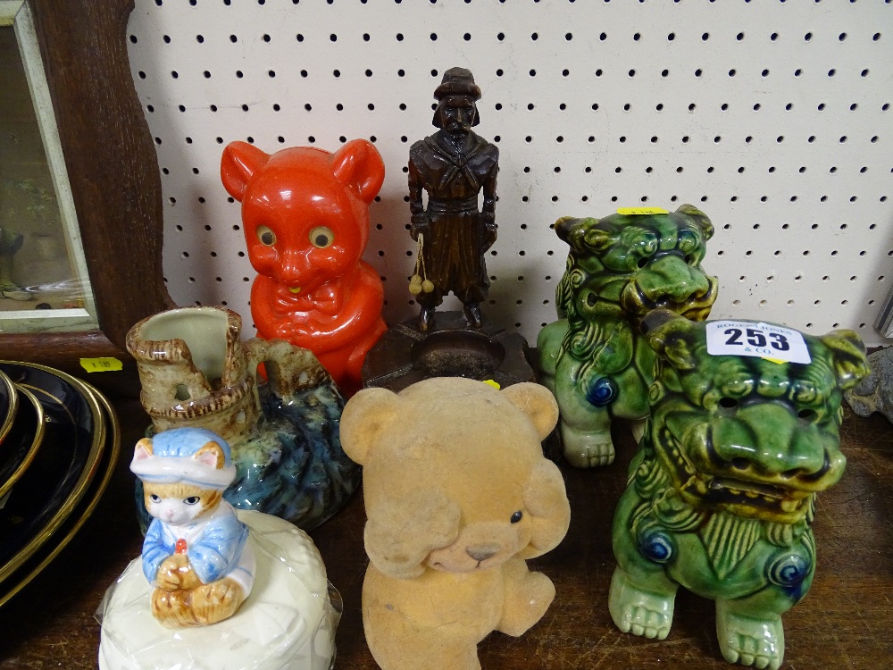 Two pottery temple lions, a bear moneybox and one other, a carved wood figural ashtray etc