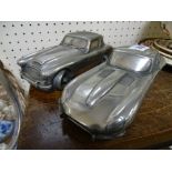 Two metallic car models, one Jaguar E-Type and MG