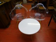 Pair of Eiffel style transparent chairs and a matching white topped occasional table