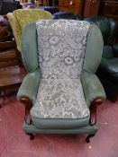 Floral green upholstered wingback chair