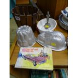 Pottery jelly mould, two tin jelly moulds, small wooden planter, small metallic presentation