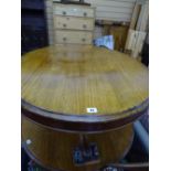 Oval mahogany coffee table on tripod scroll feet supports