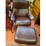 Burgundy faux leather upholstered Restless easy chair and footstool
