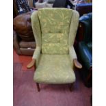 Light coloured floral upholstered easy chair with wooden arms